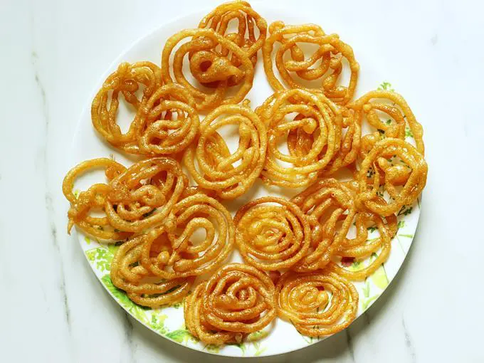 remove Jalebi from sugar syrup and spread on a plate