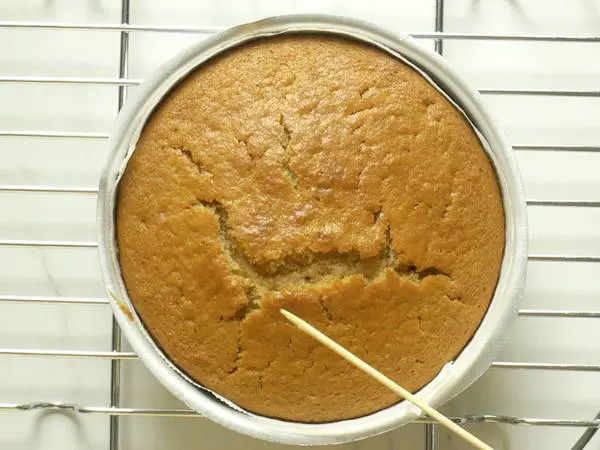 A cake tester inserted comes out clean or with slight crumbs