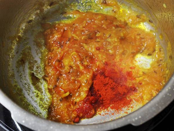 adding spice powders to make dalia khichdi recipe