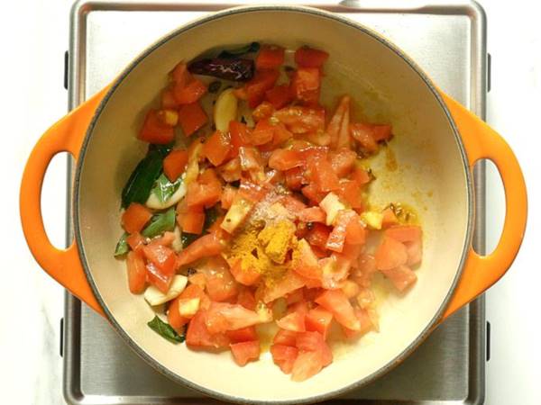 adding tomatoes to make rasam recipe