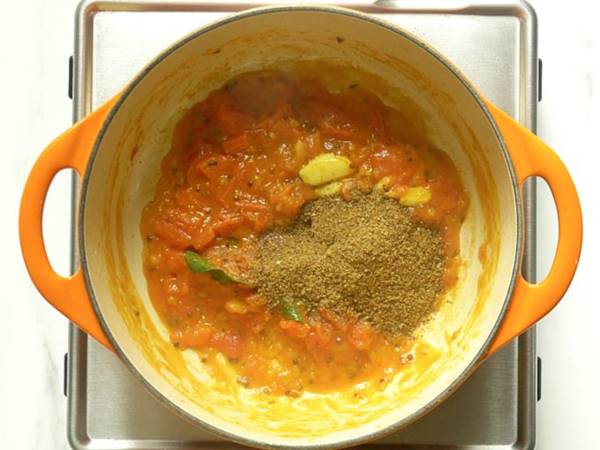 adding rasam powder to pot