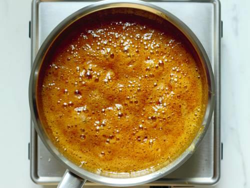 boiling jaggery syrup to make antina unde