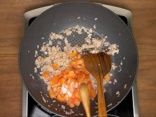 adding tomatoes salt to make bhindi masala