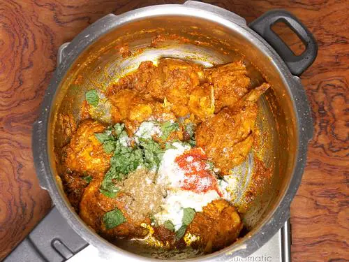 adding curd spices to make chicken biryani