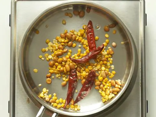 frying red chilies to make allam chutney