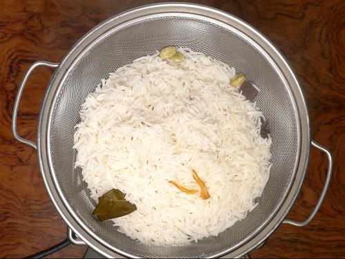 draining basmati rice to colander for  hyderabadi biryani recipe