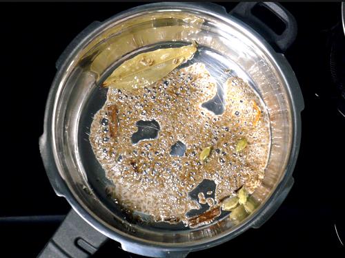 sauteing spices in ghee to make jeera rice