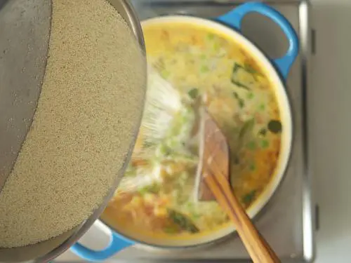 pouring rava in a stream to make khara bath