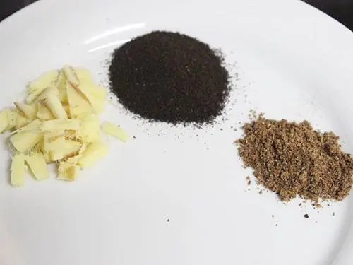 chopped ginger with tea powder & masala to make chai