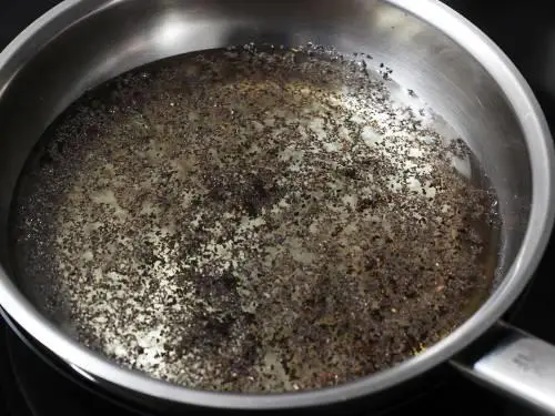 simmering tea powder in water to make masala chai