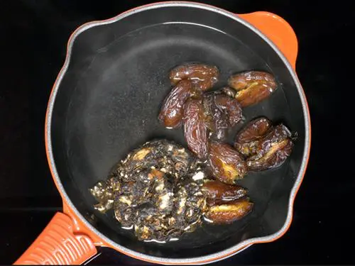 boiling dates tamarind in water to make tamarind chutney