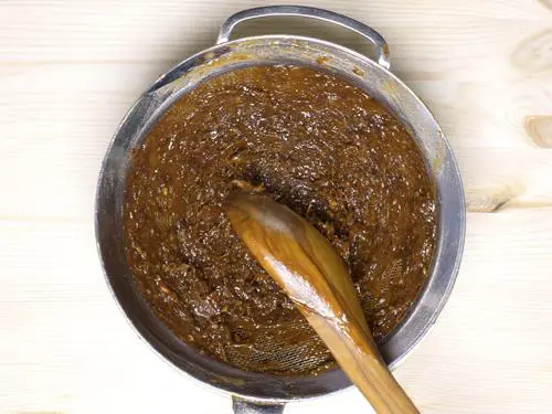 passing tamarind chutney through sieve