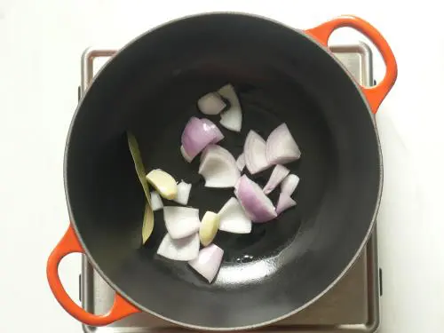 frying onions garlic bay leaf to make tomato soup recipe