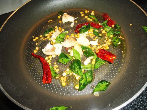 seasoning with curry leaves garlic to make allam pachadi