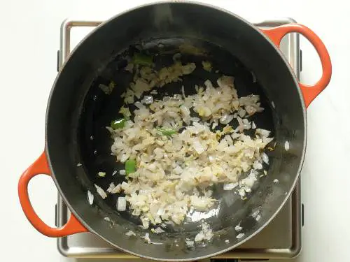 frying onions until golden to make aloo gobi