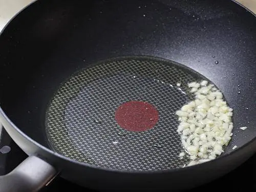 frying garlic in a pan