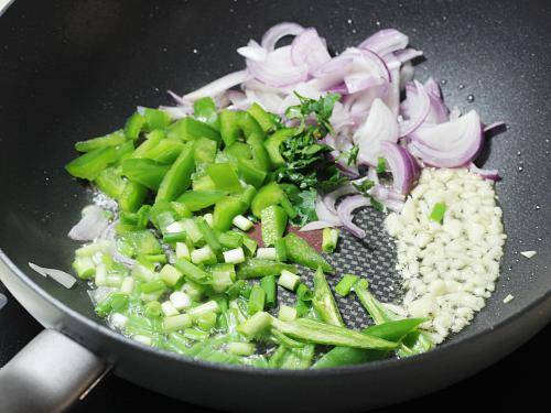 adding onions bell peppers to make chilli chicken