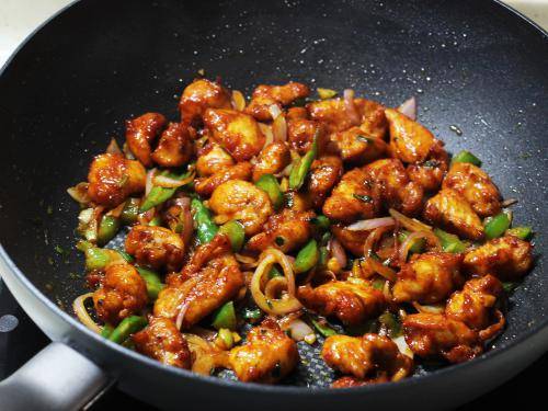 Tossing chilli chicken in pan