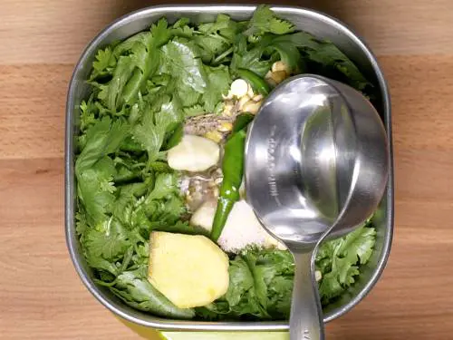 pouring water to make green chutney