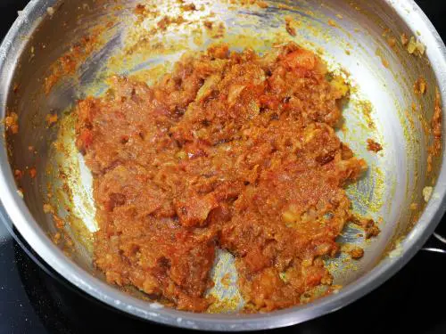 frying onion tomato masala for potato curry