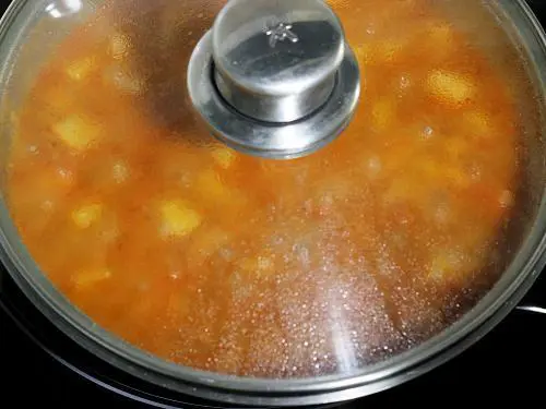cooking potato curry in a pan