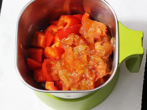 adding tomatoes to blender for red sauce pasta