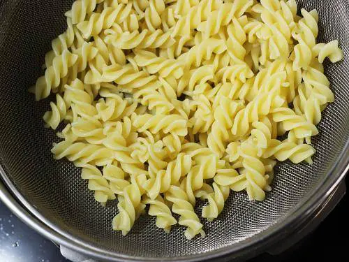 draining cooked pasta