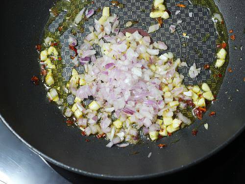 adding onions to make red sauce pasta