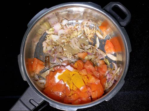 adding tomatoes turmeric salt