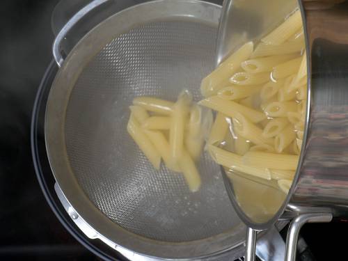 draining pasta to a colander