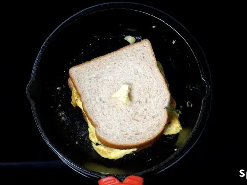 toasting egg bread omelette in a pan with butter