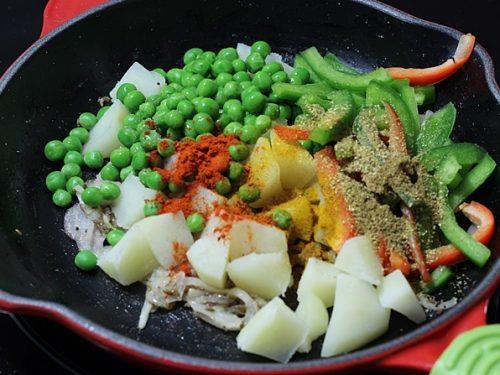 adding veggies to make kati roll mixture