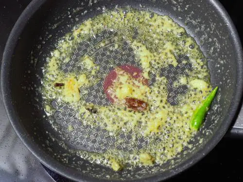 adding ginger garlic paste to make paneer makhani 