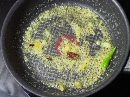 adding ginger garlic paste to make paneer makhani