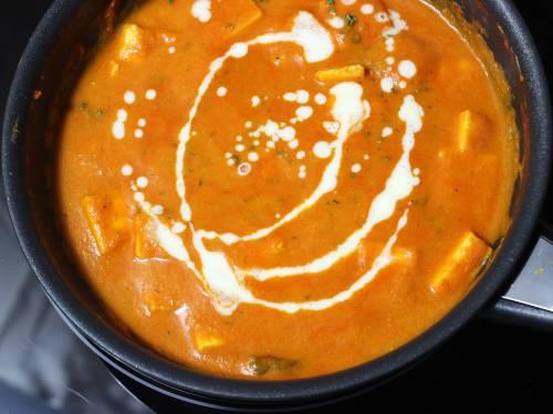 adding cream to paneer makhani