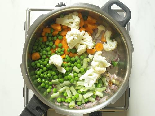 adding mixed veggies to make veg biryani