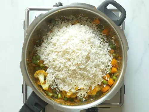 adding rice to the pot