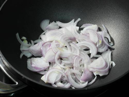 frying onions to make chana masala