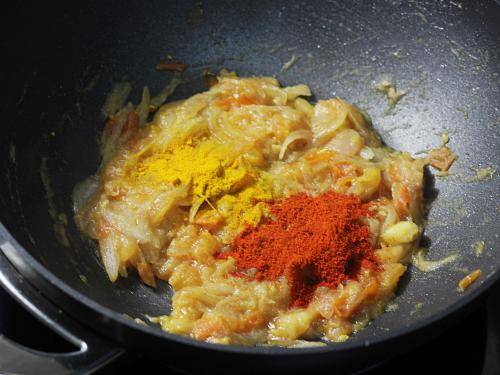 adding spice powders to make chana masala