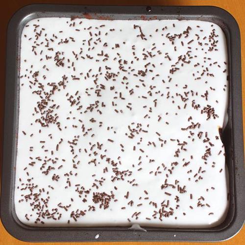 whipped cream frosting over chocolate poke cake