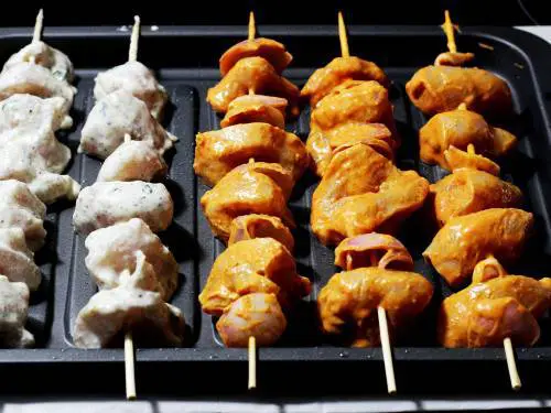 preheat oven and line the chicken on skewers