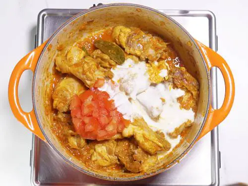 adding tomatoes and curd