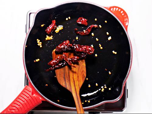 frying red chilies in oil
