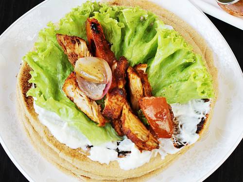 place chicken shawarma on pita bread