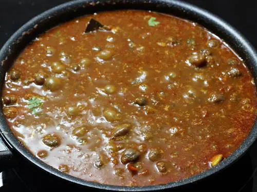 cooking chole in black pan
