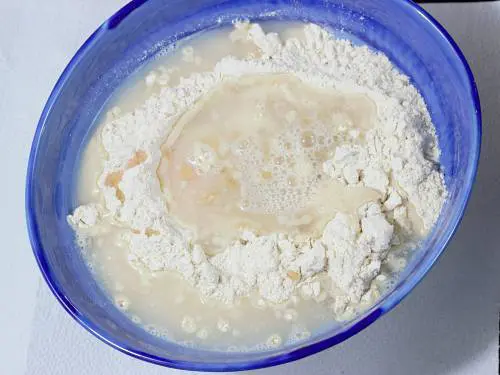 pouring water to knead dough