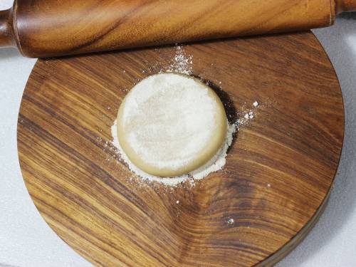 flatten dough ball to make paratha