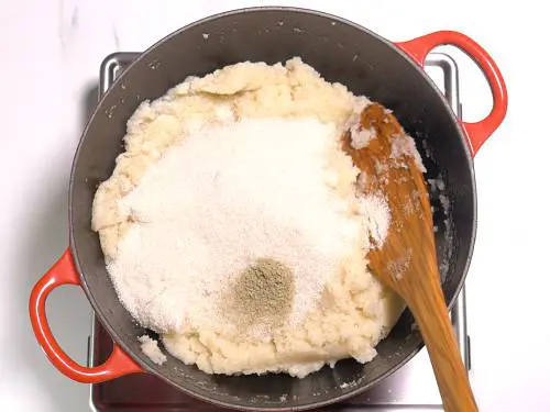 adding sugar and cardamom powder