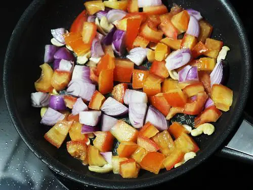 frying onions tomatoes in pan