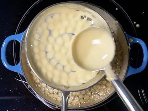 pouring batter to hot oil for boondi laddu recipe